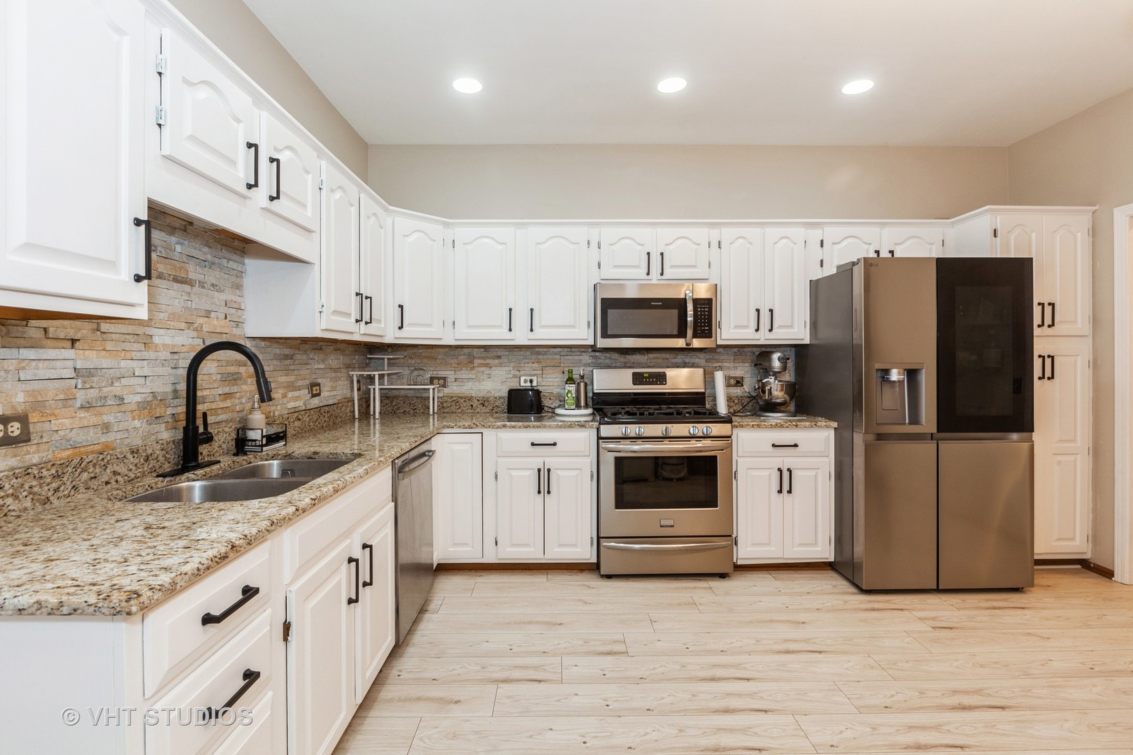960 Heathrow Lane Naperville, IL 60540 - Photo 9 of 24 a kitchen with stainless steel appliances granite countertop a sink a stove a refrigerator and cabinets