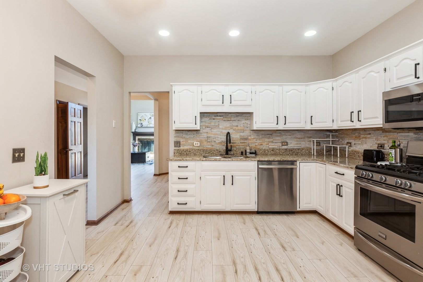 960 Heathrow Lane Naperville, IL 60540 - Photo 10 of 24 a kitchen with stainless steel appliances white cabinets sink and stove