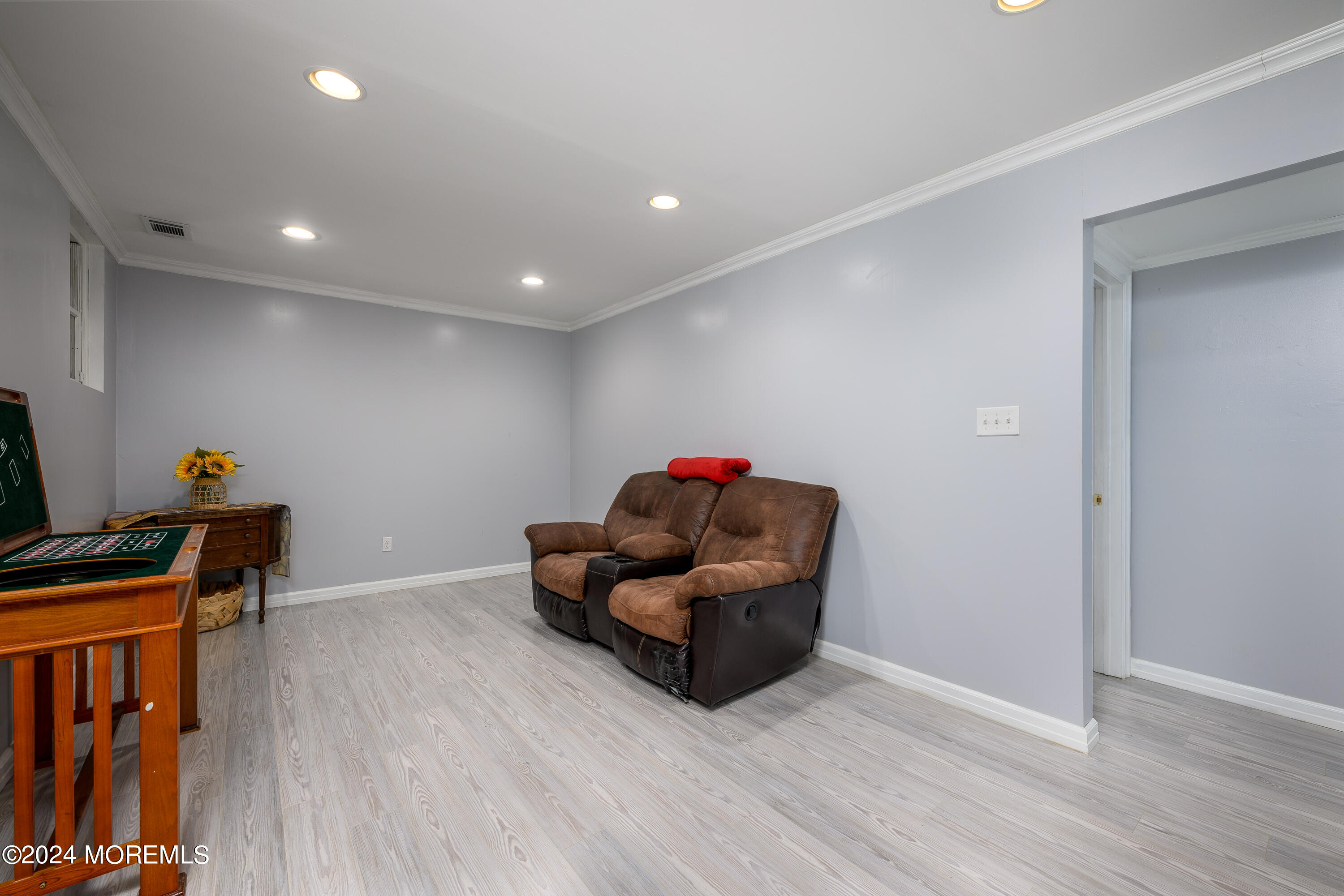 28 Chestnut Hill Road Howell, NJ 07731 - Photo 24 of 48 a living room with furniture and a wooden floor