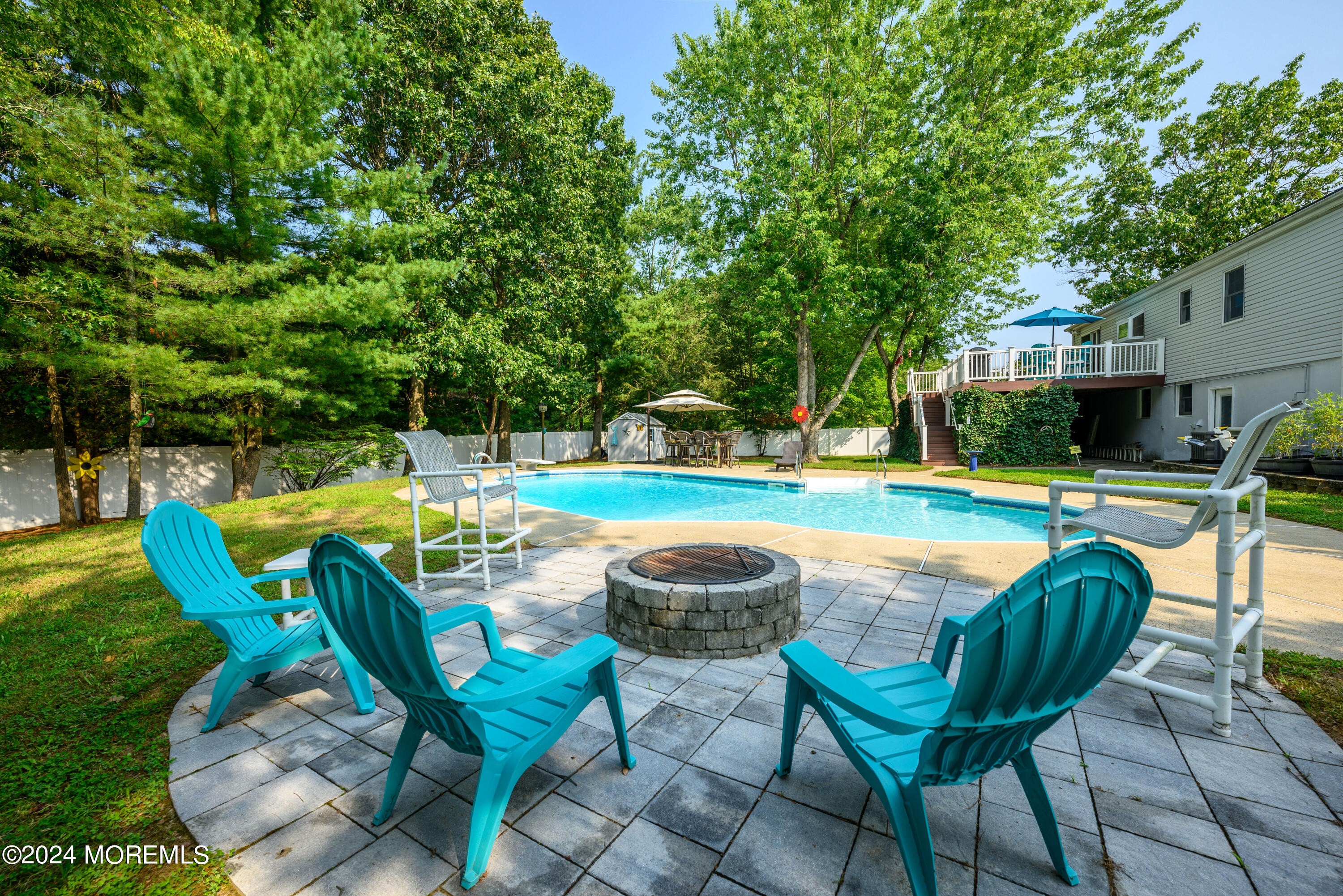 28 Chestnut Hill Road Howell, NJ 07731 - Photo 33 of 48 a view of swimming pool with lawn chairs and plants