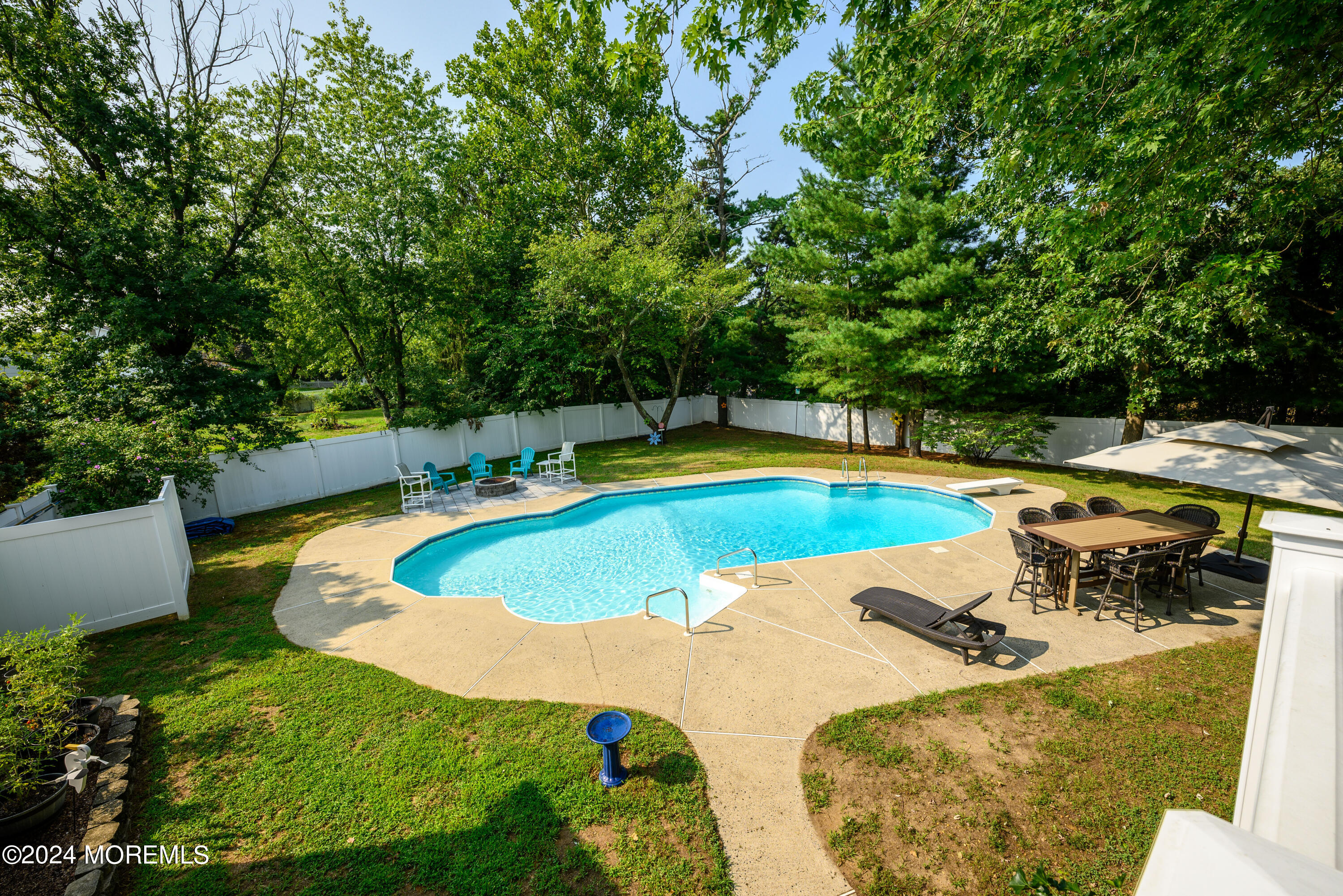 28 Chestnut Hill Road Howell, NJ 07731 - Photo 42 of 48 a view of a swimming pool with a yard