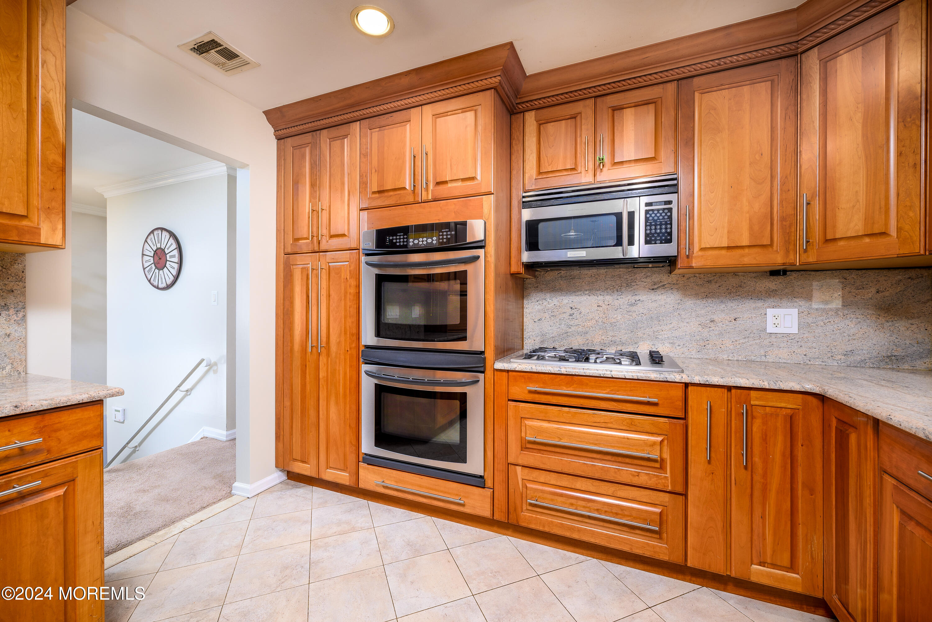 28 Chestnut Hill Road Howell, NJ 07731 - Photo 6 of 48 a kitchen with stainless steel appliances granite countertop a stove and a microwave oven