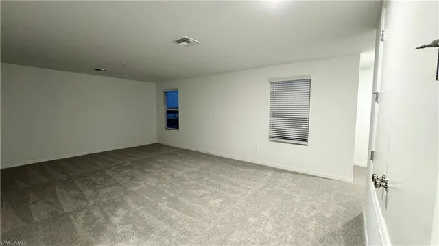 a spacious bathroom with a double vanity sink a mirror and a bathtub