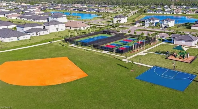 an aerial view of residential houses with outdoor space and pool