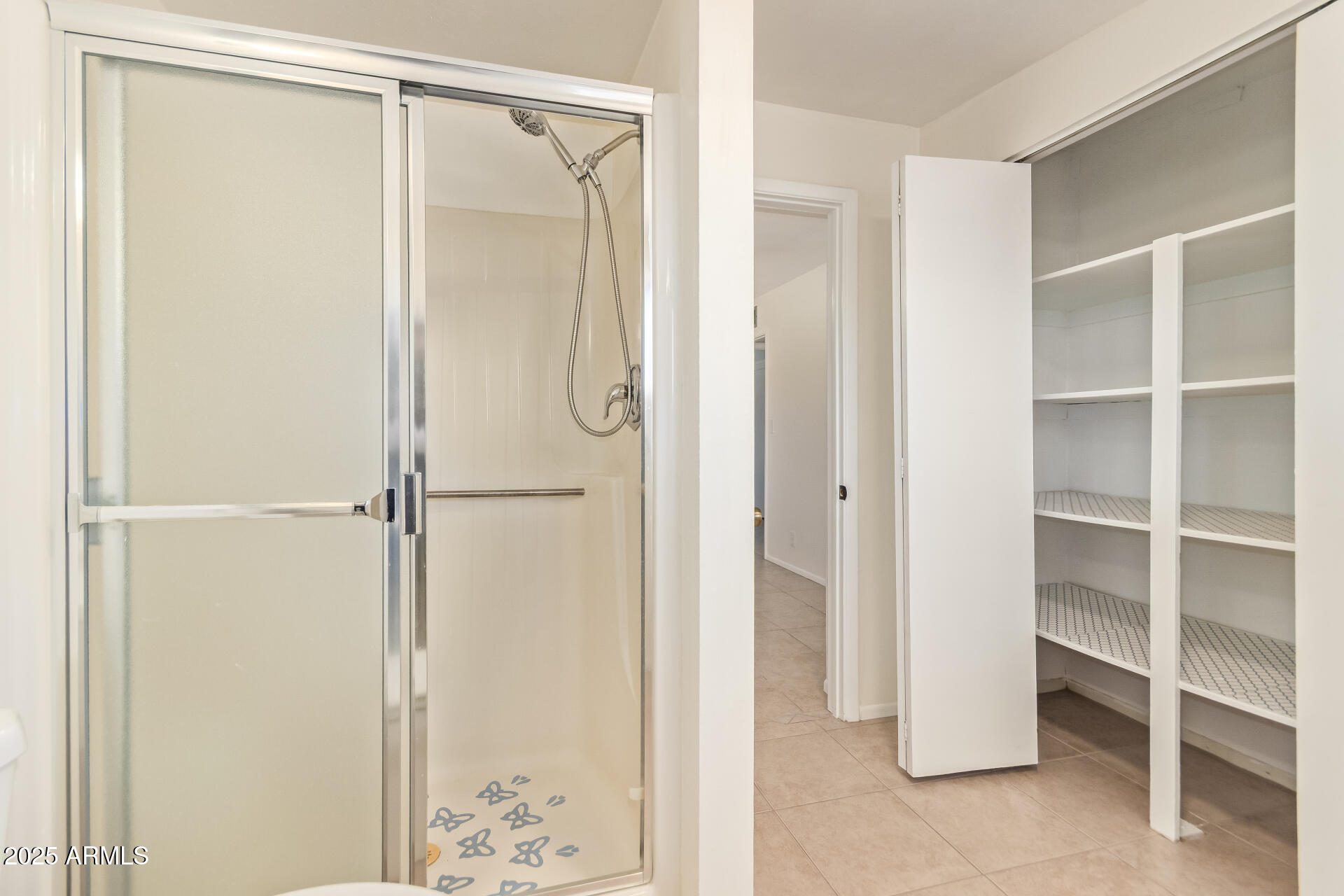 6066 East Decatur Street Mesa, AZ 85205 - Photo 16 of 28 a bathroom with a glass shower door