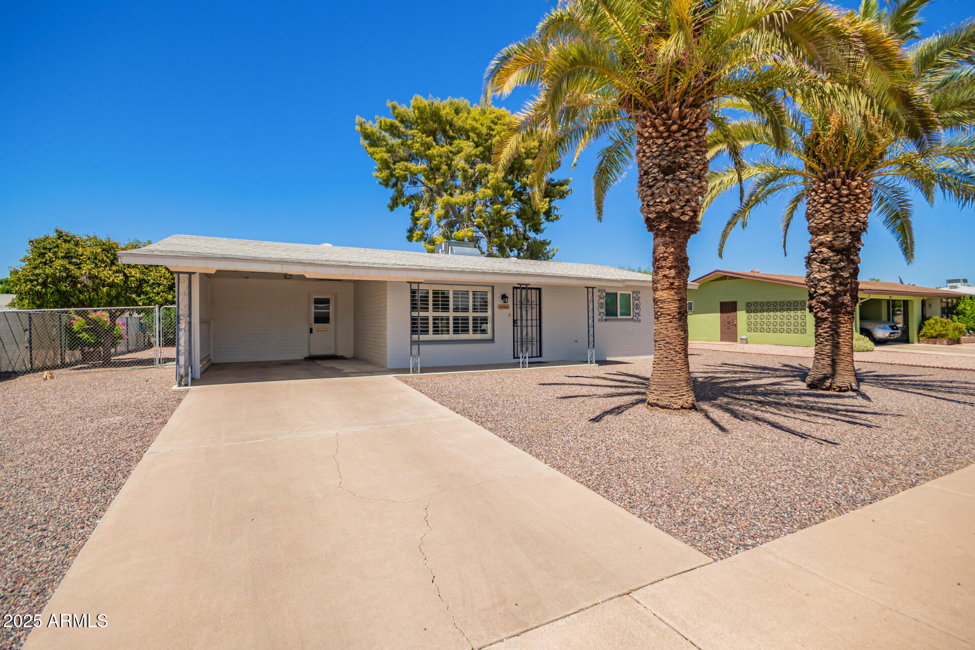 6066 East Decatur Street Mesa, AZ 85205 - Photo 4 of 28 a view of a house with a yard and garage