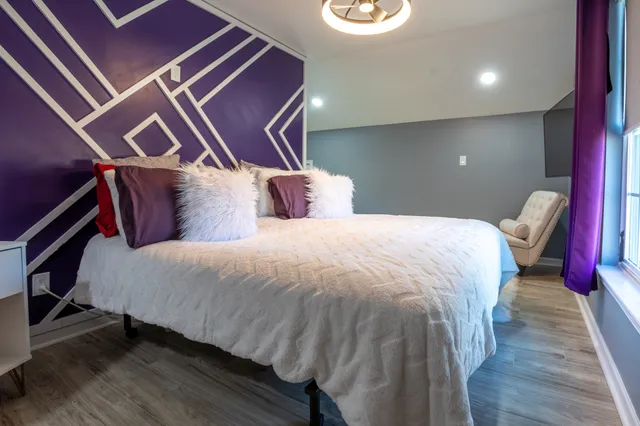 a bedroom with a bed and a lamp