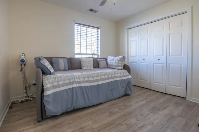 a living room with a bed and a window
