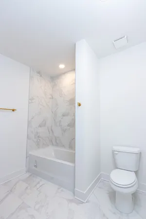 a bathroom with a toilet and a shower