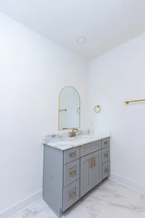 a bathroom with a double vanity sink and a mirror