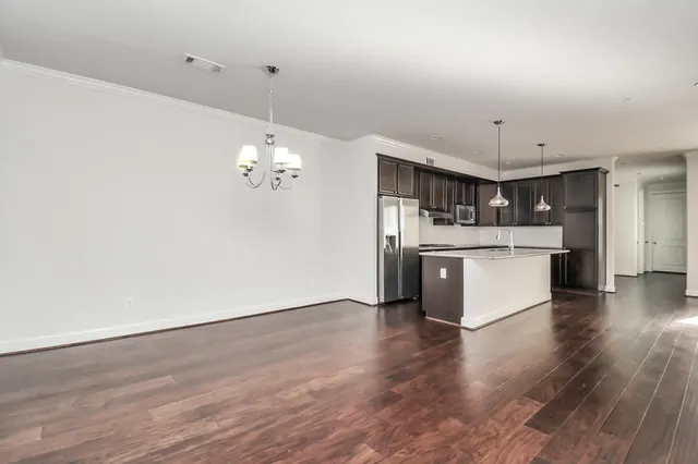 a view of a kitchen with a sink wooden floor and a window