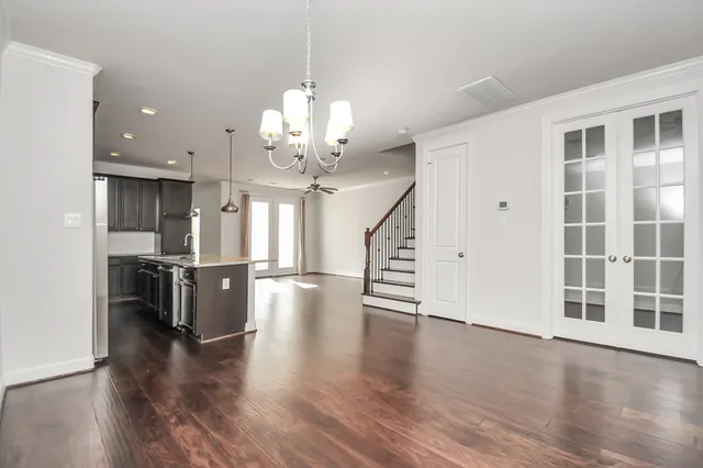 a view of a room with wooden floor and stainless steel appliances