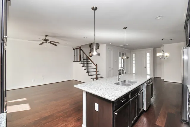 a kitchen with center island and wooden floor