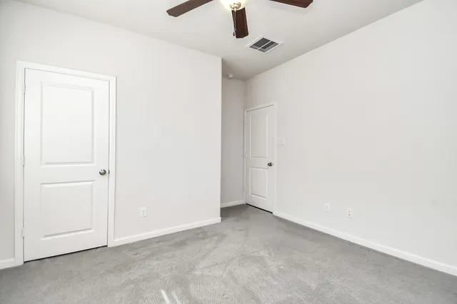 an empty room with a ceiling fan