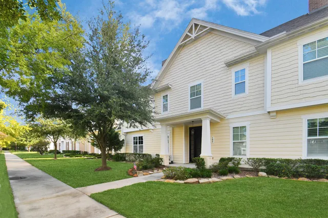 a view of a house with a yard and plants