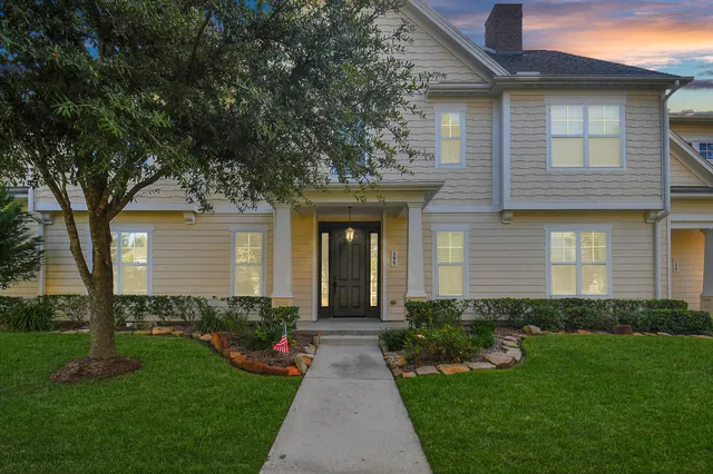 a front view of a house with a garden and plants