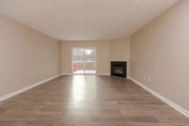 wooden floor fireplace and natural light in room