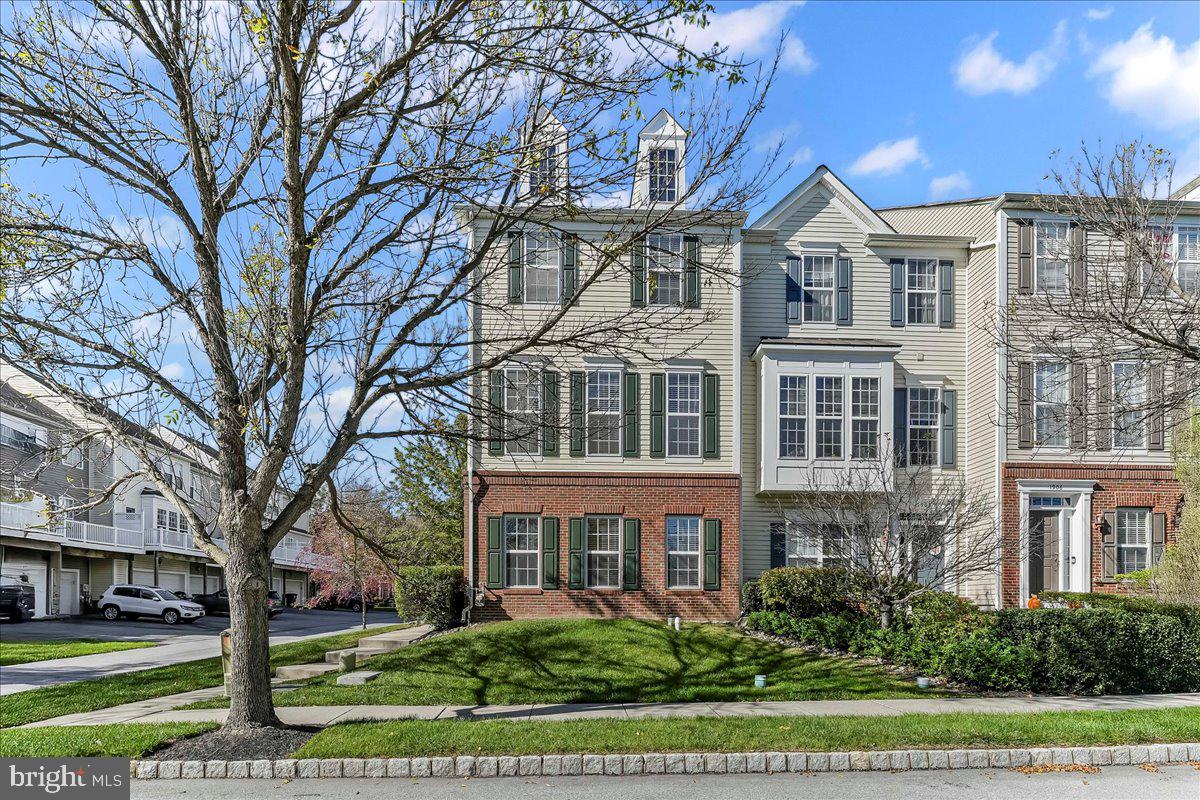 1910 Cavalier Lane Chester Springs, PA 19425 - Photo 1 of 32 a view of a white house next to a yard with big trees