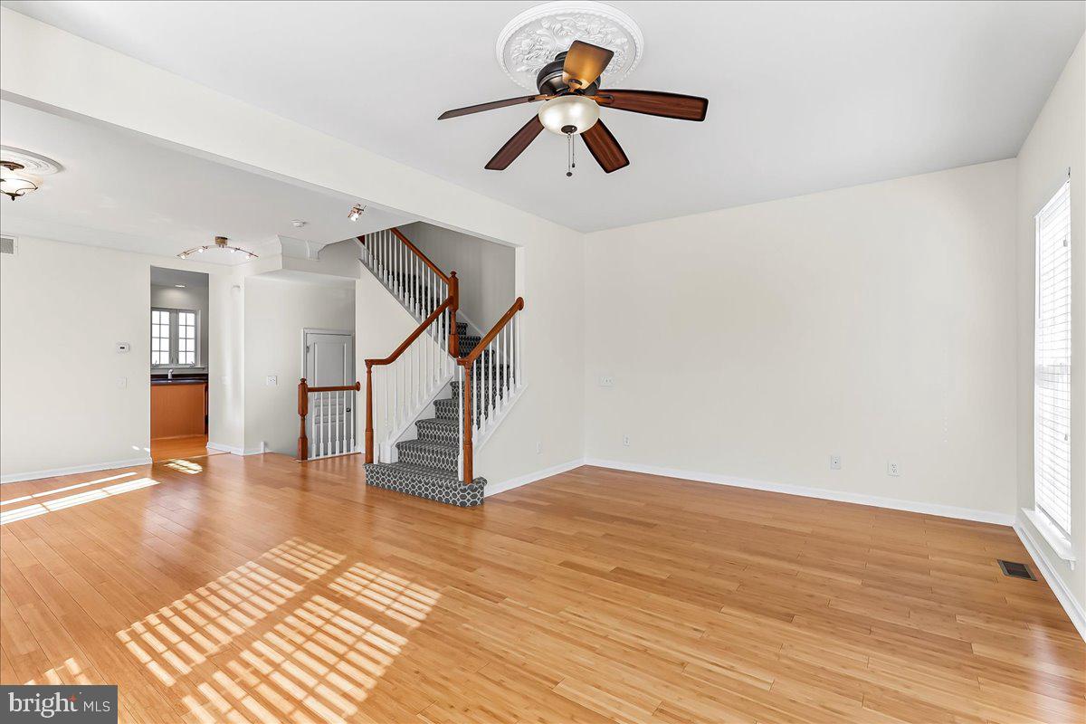 1910 Cavalier Lane Chester Springs, PA 19425 - Photo 12 of 32 a view of an empty room with wooden floor ceiling fan