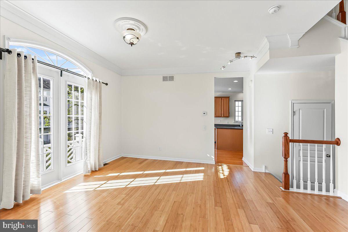 1910 Cavalier Lane Chester Springs, PA 19425 - Photo 13 of 32 an empty room with wooden floor and windows