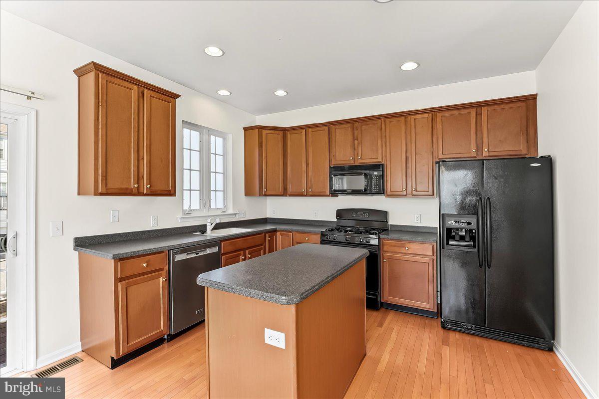 1910 Cavalier Lane Chester Springs, PA 19425 - Photo 18 of 32 a kitchen with a refrigerator sink and wooden cabinets