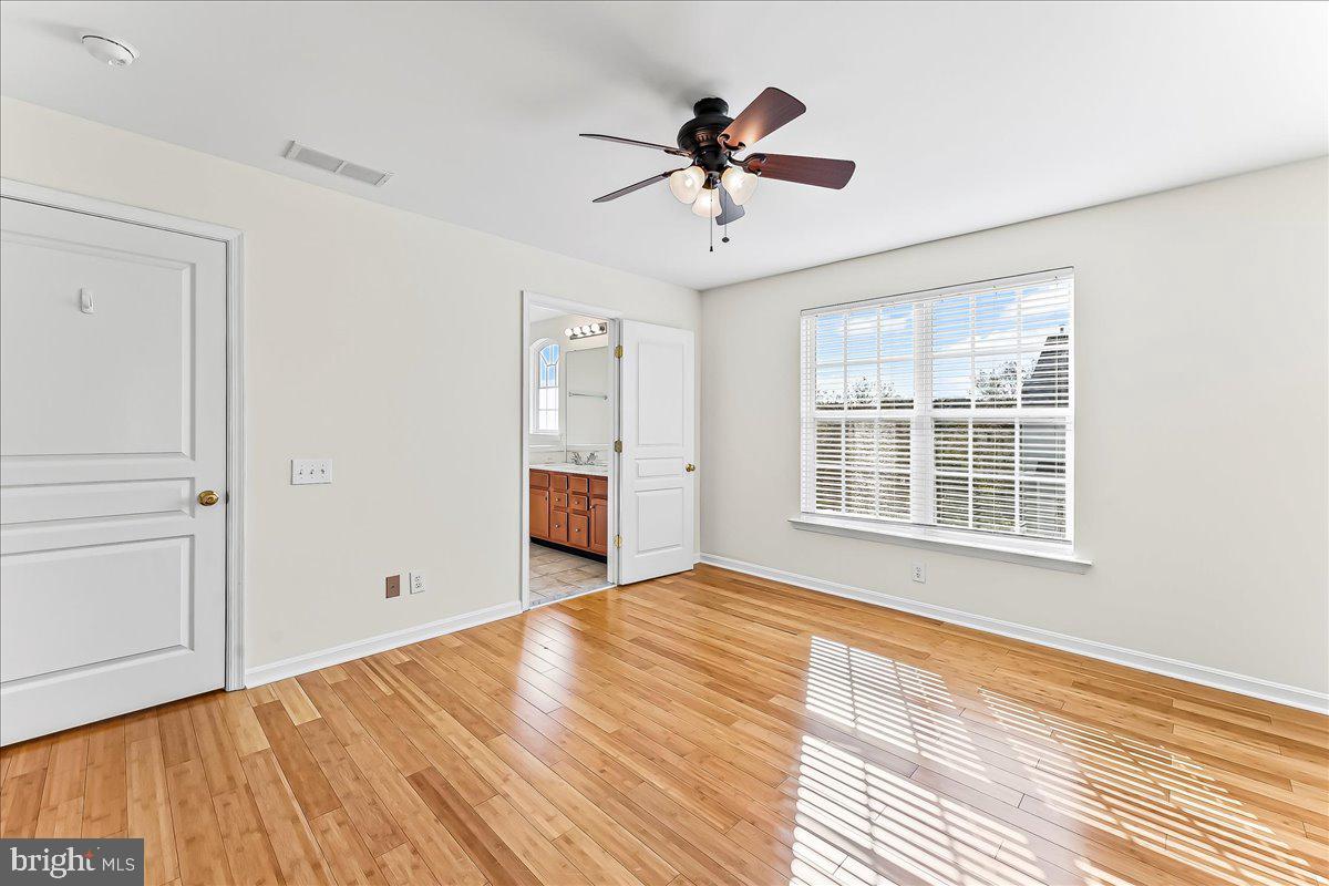 1910 Cavalier Lane Chester Springs, PA 19425 - Photo 19 of 32 a view of an empty room with a window and wooden floor