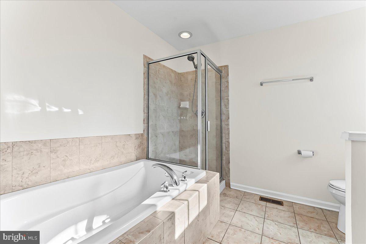 1910 Cavalier Lane Chester Springs, PA 19425 - Photo 21 of 32 a bathroom with a bathtub and a shower