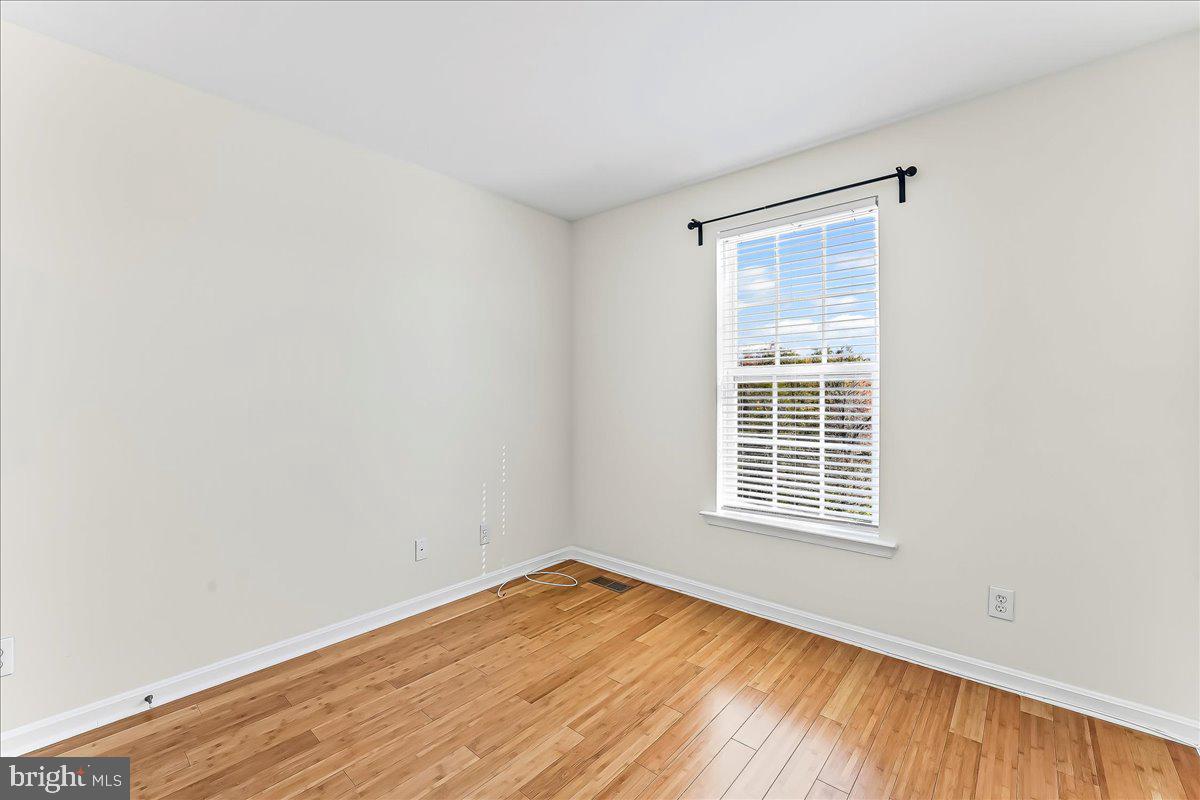 1910 Cavalier Lane Chester Springs, PA 19425 - Photo 25 of 32 a view of empty room with wooden floor and fan