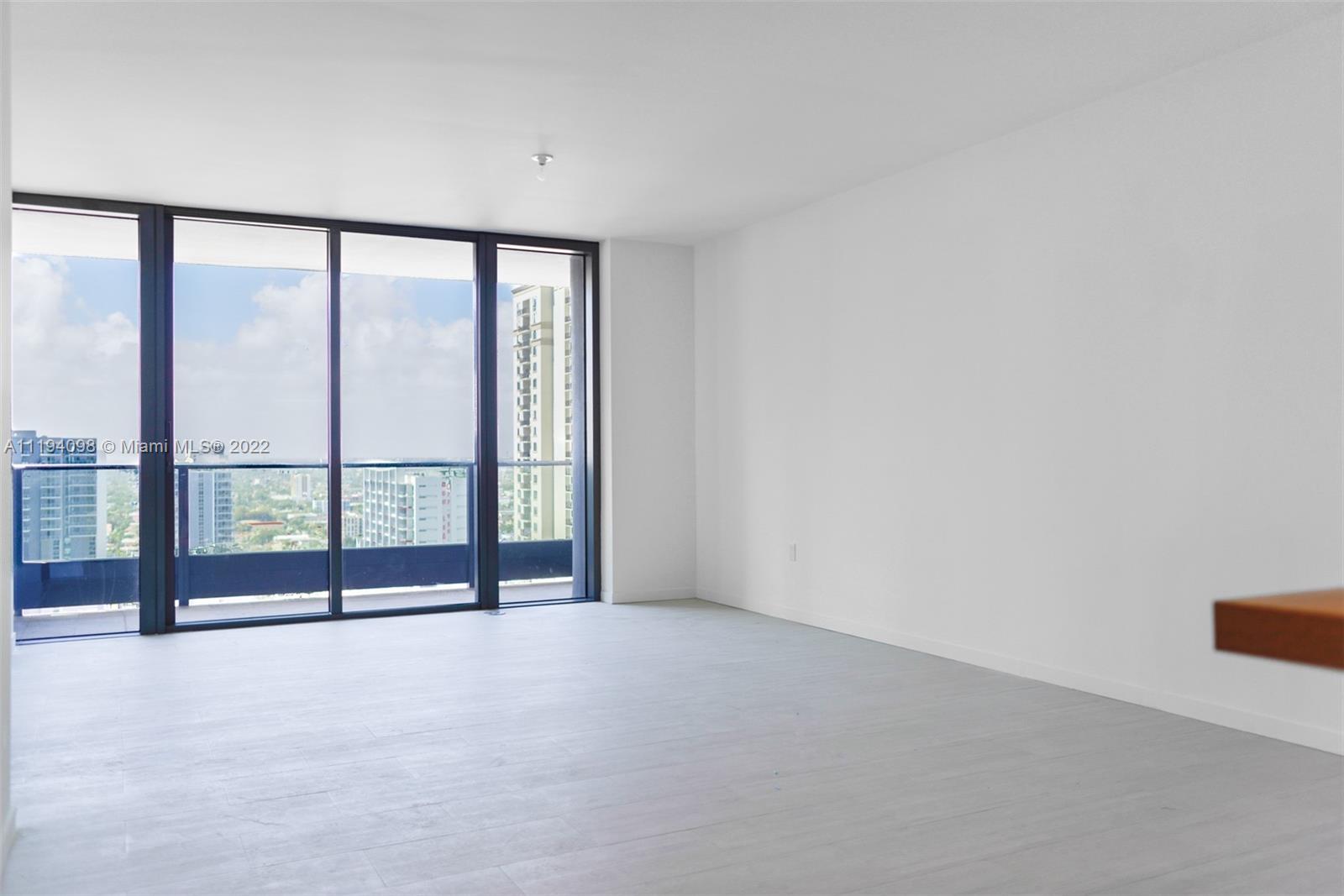a view of an empty room with a large window