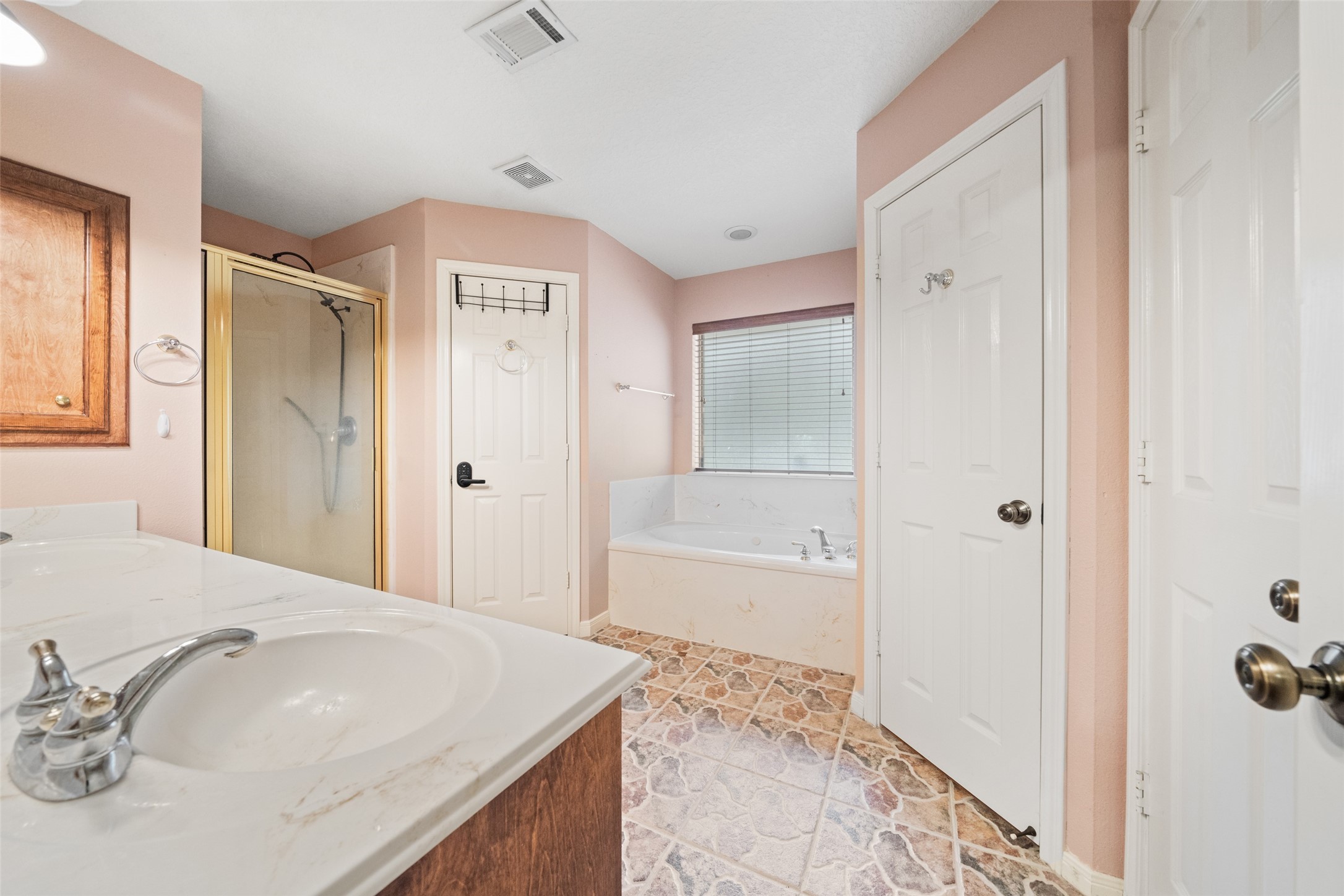 7863 Rodeo Road Waller, TX 77484 - Photo 20 of 36 a bathroom with a granite countertop sink a mirror and a bathtub