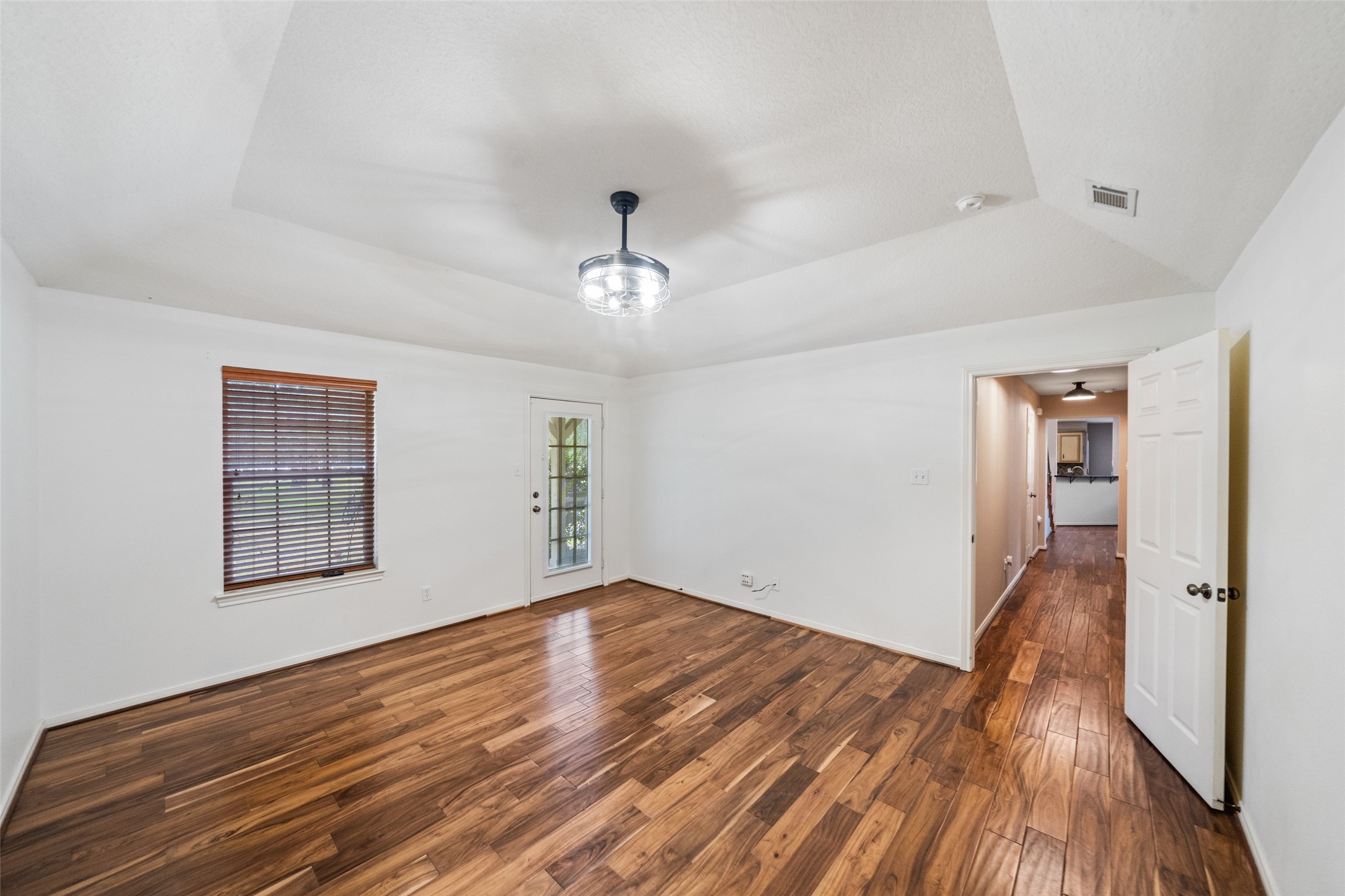 7863 Rodeo Road Waller, TX 77484 - Photo 22 of 36 a view of empty room with wooden floor and fan