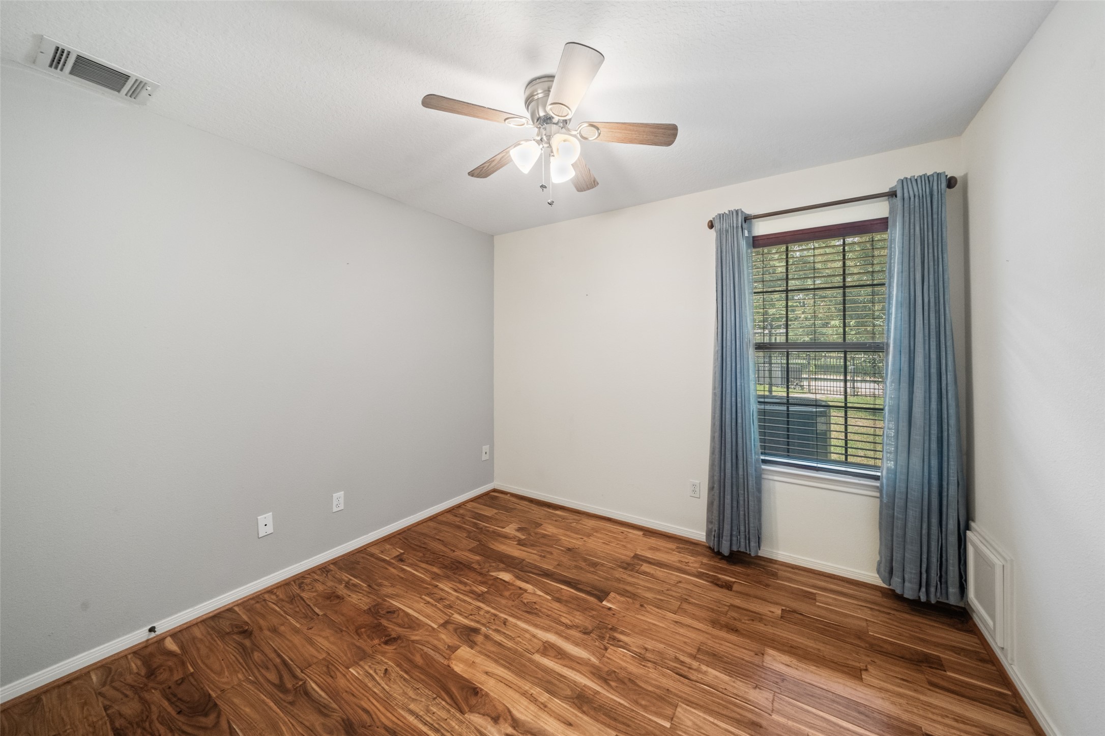 7863 Rodeo Road Waller, TX 77484 - Photo 23 of 36 wooden floor in an empty room with a window