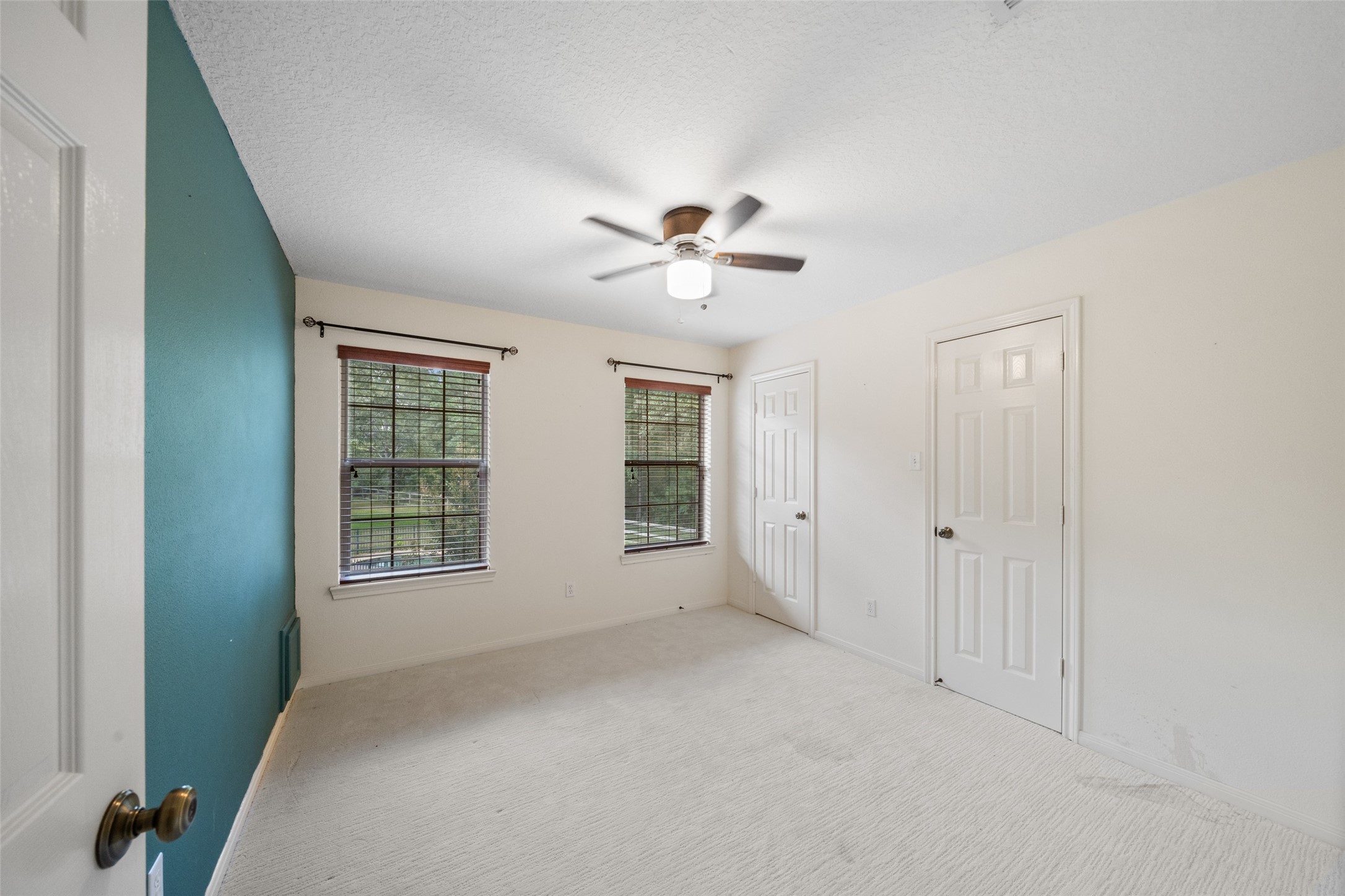 7863 Rodeo Road Waller, TX 77484 - Photo 26 of 36 an empty room with chandelier fan and windows