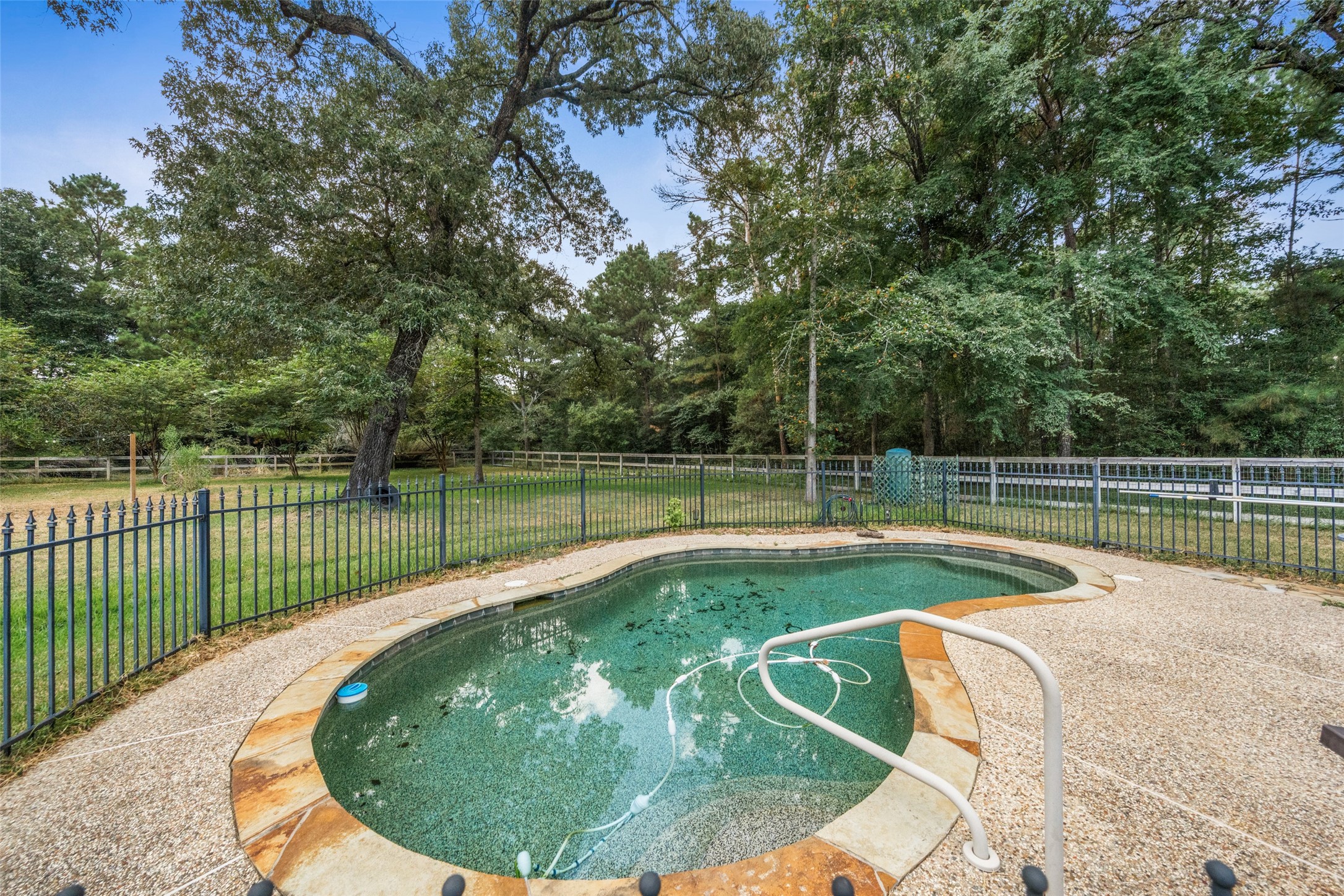 7863 Rodeo Road Waller, TX 77484 - Photo 29 of 36 a view of a swimming pool with a garden