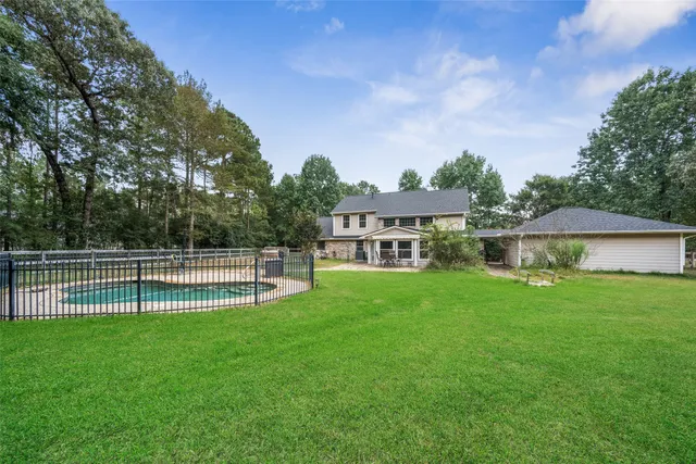 a view of a house with a yard and sitting area