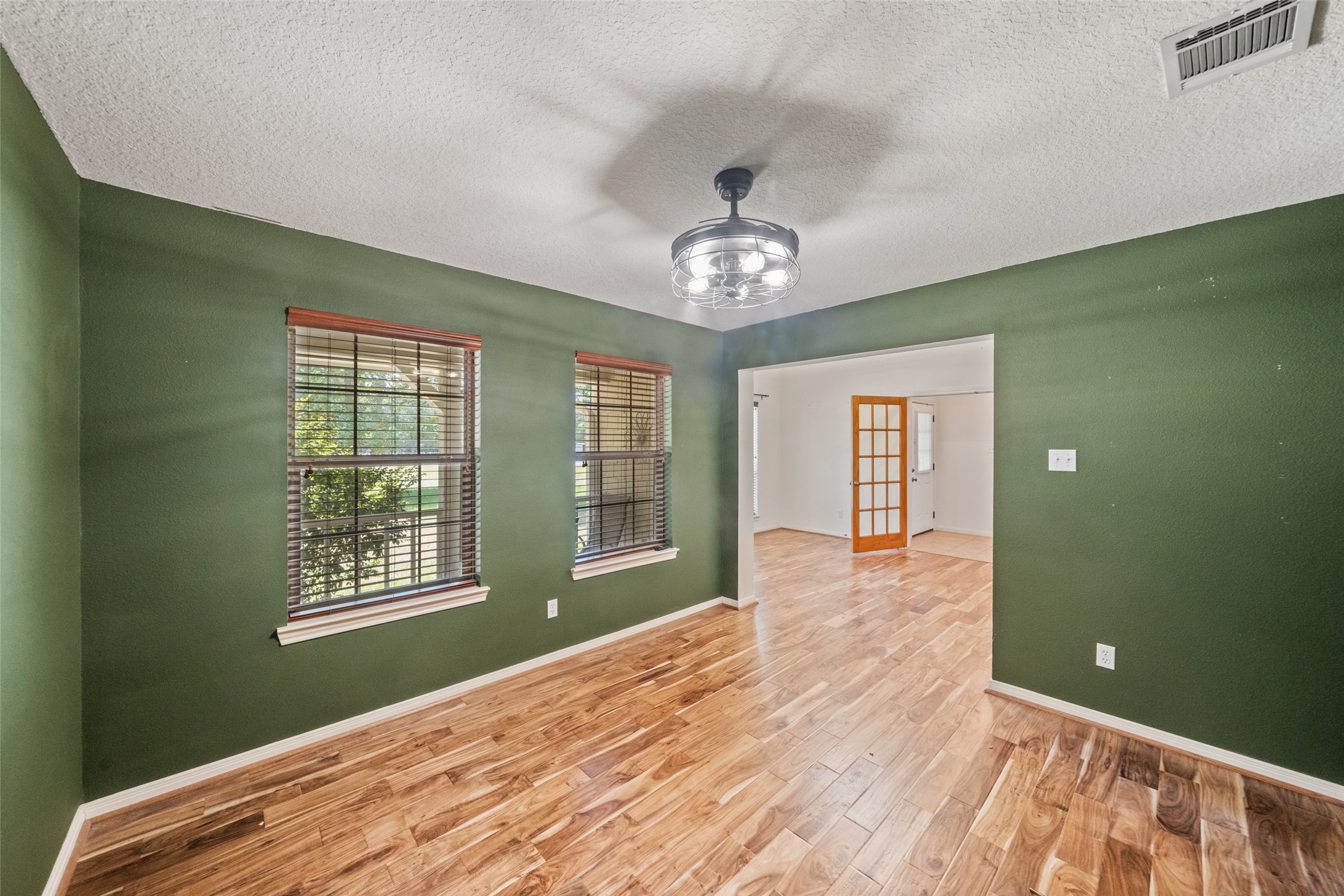 7863 Rodeo Road Waller, TX 77484 - Photo 8 of 36 a view of an empty room with a window and wooden floor