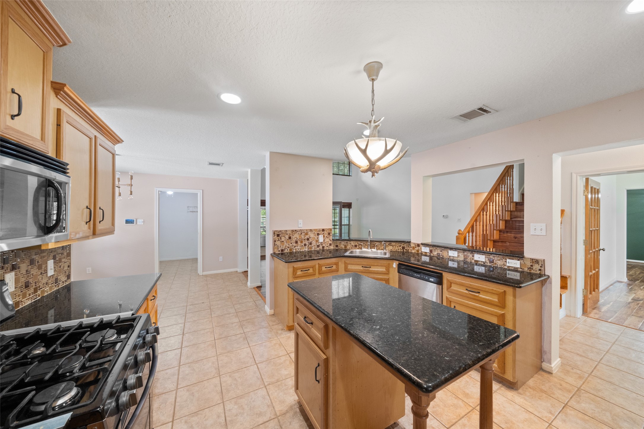 7863 Rodeo Road Waller, TX 77484 - Photo 10 of 36 a kitchen with stainless steel appliances granite countertop a granite counter tops and a stove