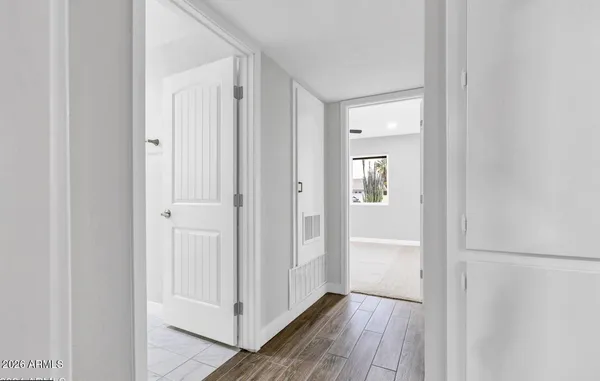 a view of a hallway with wooden floor