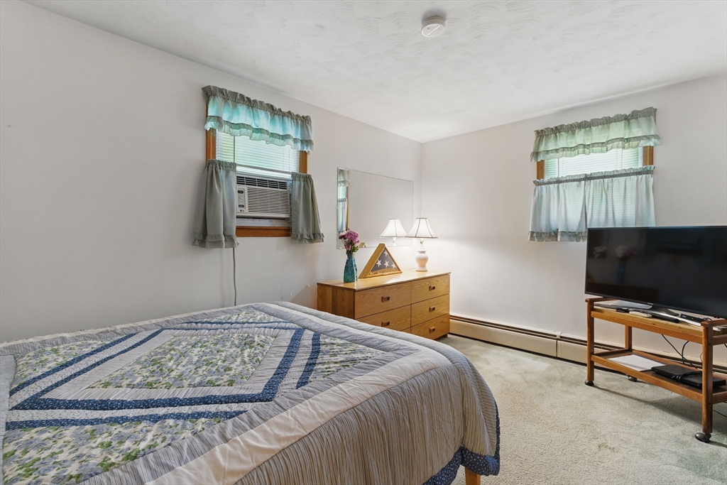17 Howard Street Enfield, CT 06082 - Photo 20 of 33 a bedroom with a bed and a flat screen tv