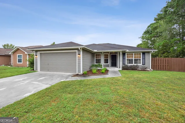 a view of a house with a yard and sitting area