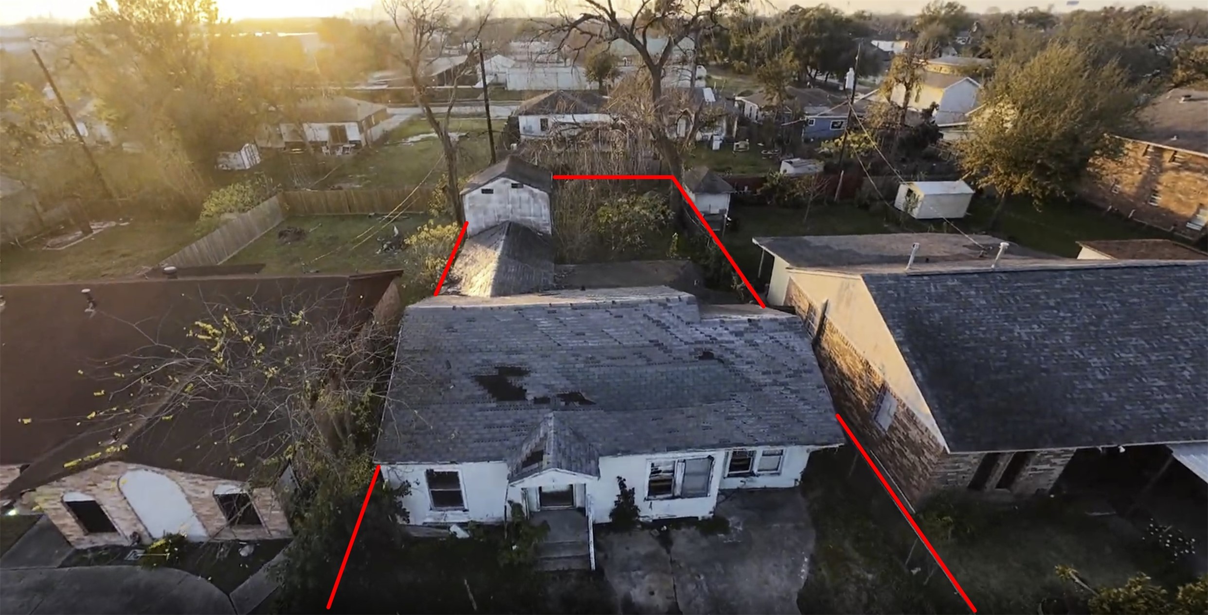 an aerial view of a houses with a yard