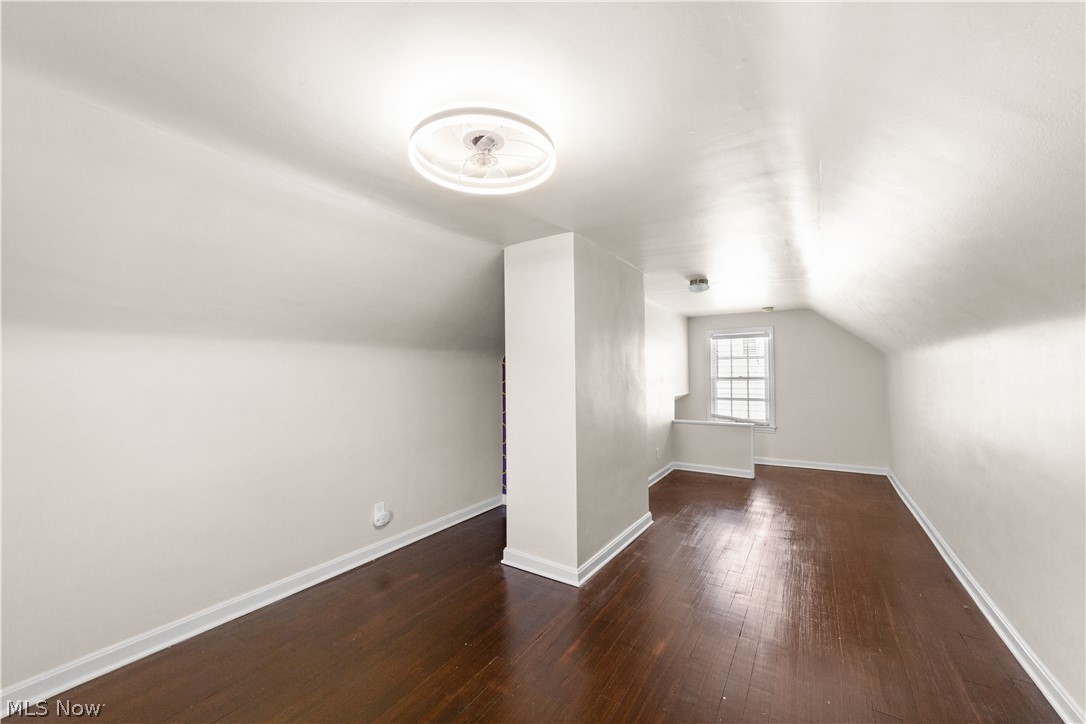 3806 Westwood Road University Heights, OH 44118 - Photo 27 of 41 Hardwood flooring throughout a spacious room with a window featuring multiple panes, white trim, and a low wall