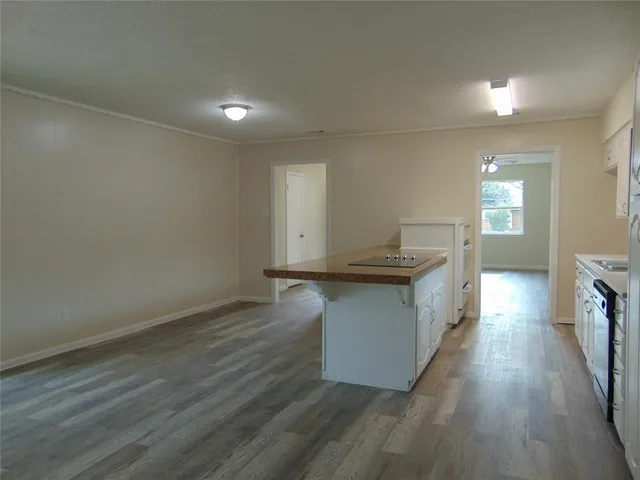 a kitchen with granite countertop a sink and wooden floor