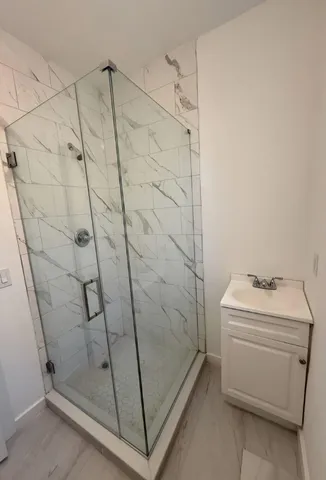 a bathroom with a shower toilet and sink