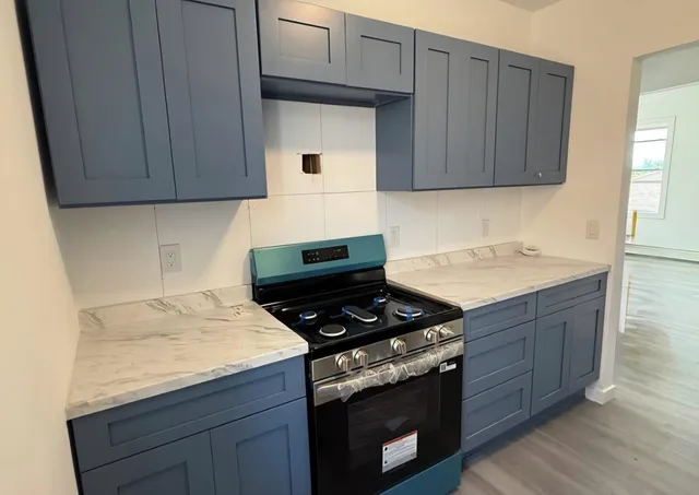 a kitchen with granite countertop wood cabinets and white appliances