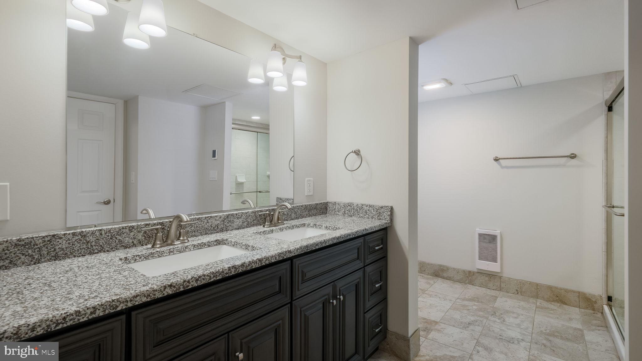 106 East State Street, Unit 4 Doylestown, PA 18901 - Photo 15 of 19 a bathroom with a granite countertop sink and a mirror