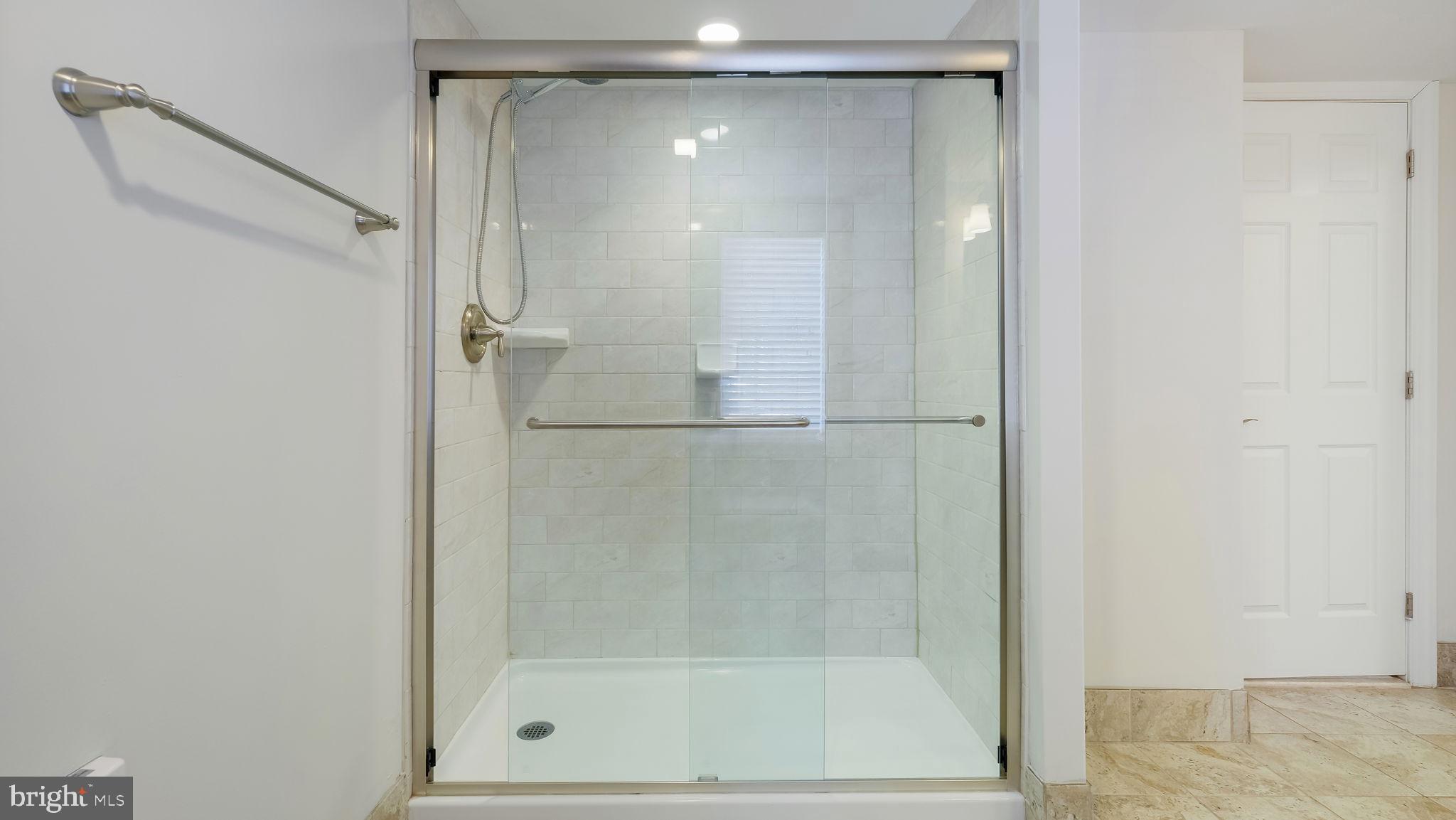 106 East State Street, Unit 4 Doylestown, PA 18901 - Photo 16 of 19 a bathroom with a glass shower door