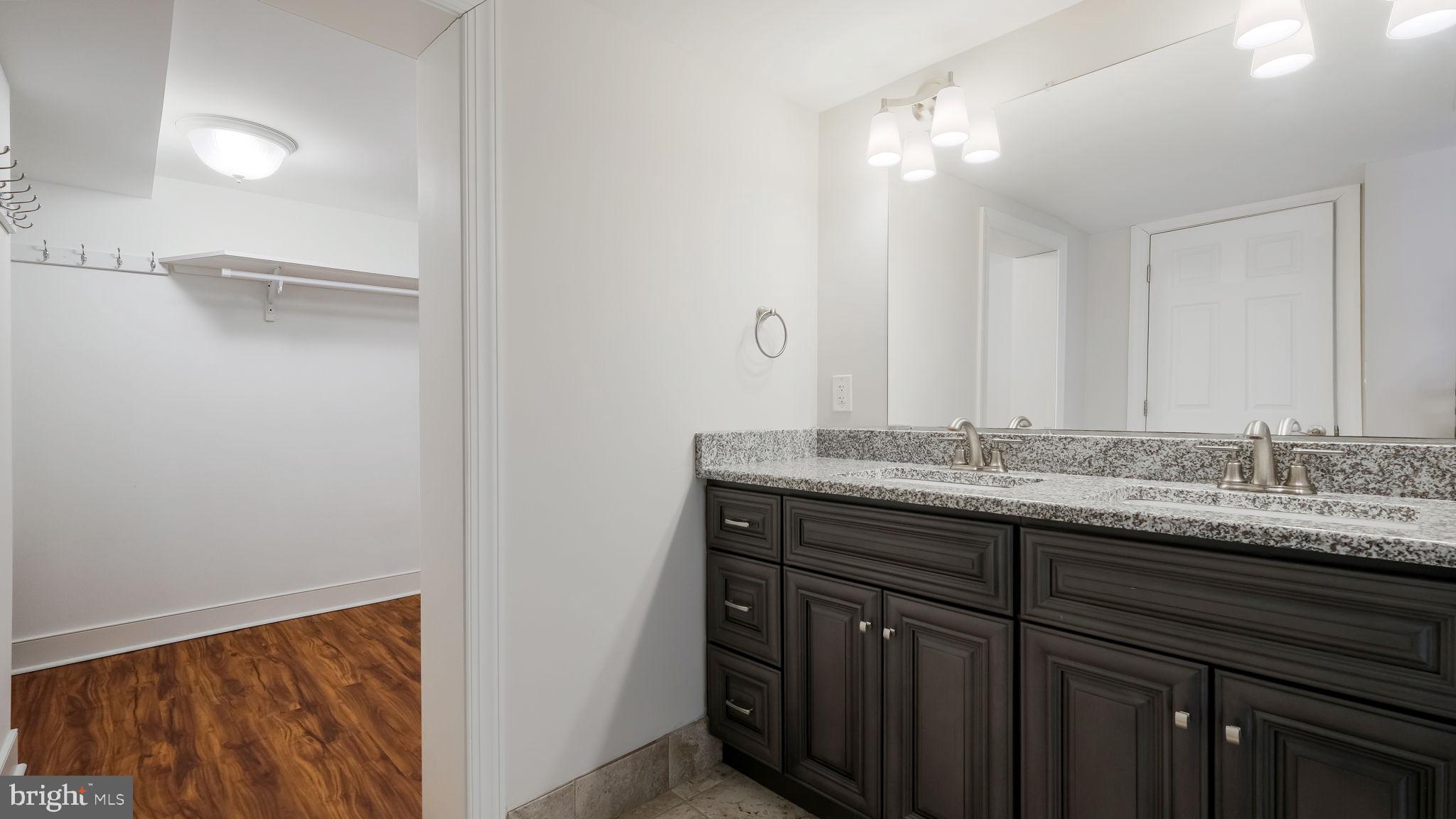 106 East State Street, Unit 4 Doylestown, PA 18901 - Photo 17 of 19 a bathroom with a granite countertop sink and a mirror