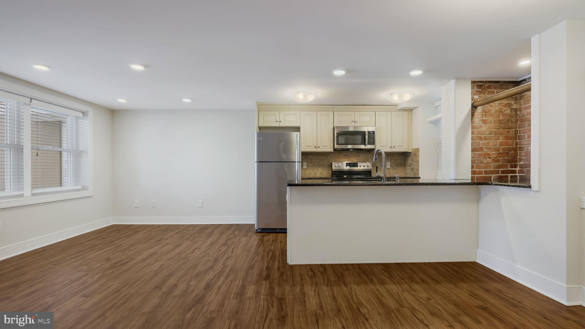 106 East State Street, Unit 4 Doylestown, PA 18901 - Photo 6 of 19 a view of kitchen with sink and wooden floor