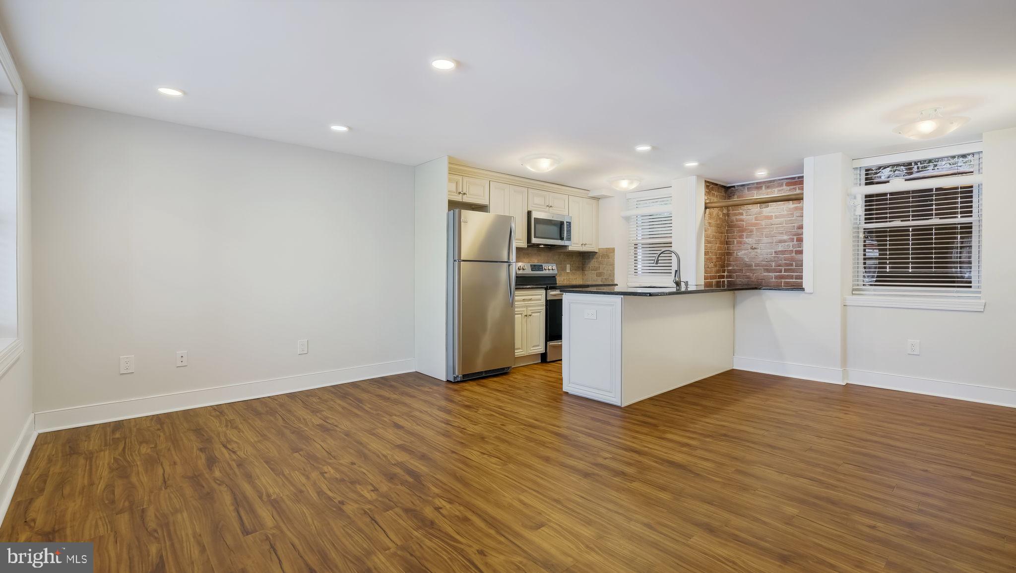 106 East State Street, Unit 4 Doylestown, PA 18901 - Photo 7 of 19 a view of kitchen with wooden floor